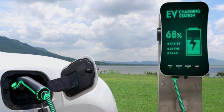 Electric car plugged in with charging station to recharge battery by EV charger cable with nature and lake background. Future innovative ev car and energy sustainability. Peruse