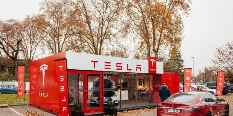 PARIS, FRANCE - NOVEMBER 29: Customer admiring new Tesla Model S at showroom  in Paris, France. Tesla is an American company that designs, manufactures, and sells electric cars
